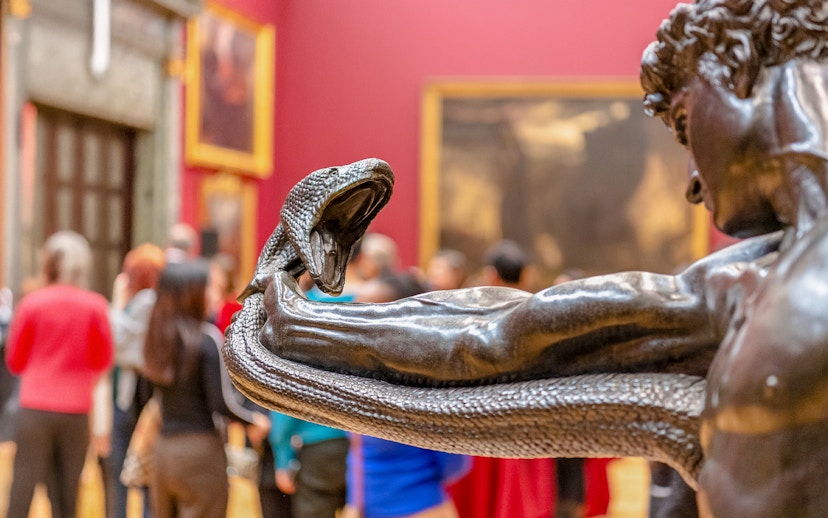 Sculpture of a man wrestling a serpent at Tate Britain exhibit.
