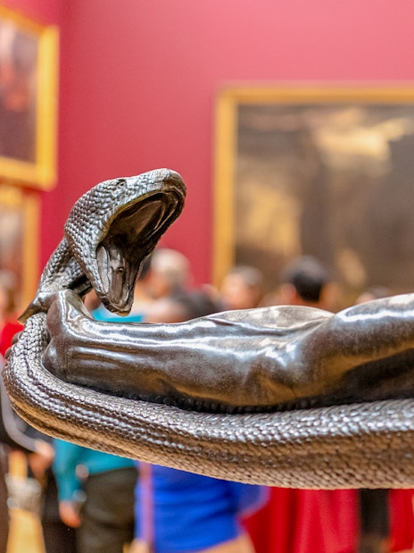 Sculpture of a man wrestling a serpent at Tate Britain exhibit.