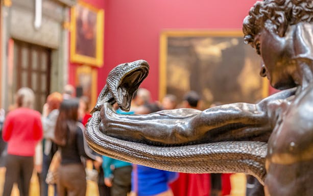 Sculpture of a man wrestling a serpent at Tate Britain exhibit.