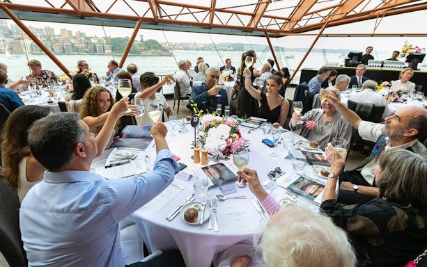 Guests toasting at a table during the NYE Opera Gala at Sydney Opera House.