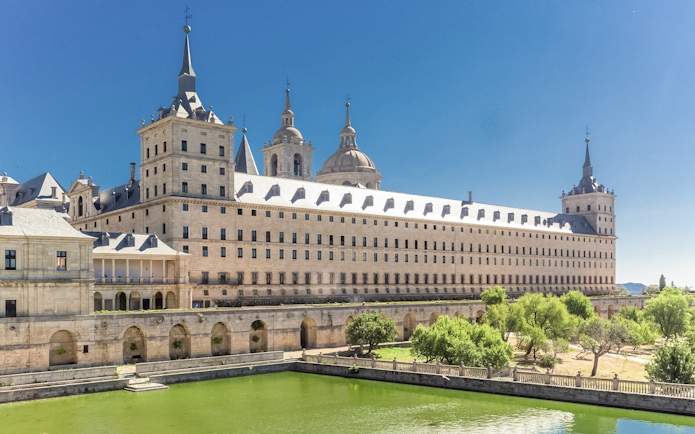 El Escorial Monastery in Spain with its grand architecture and surrounding greenery.