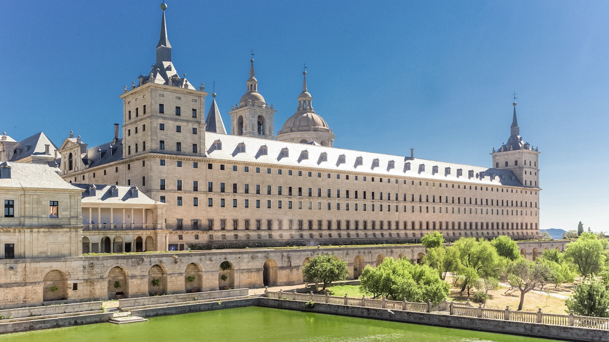 El Escorial Monastery in Spain with its grand architecture and surrounding greenery.