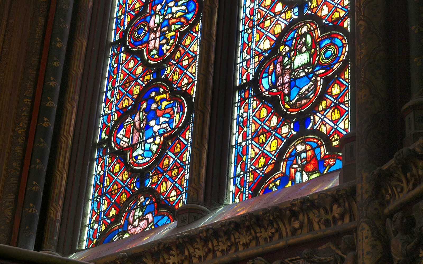 Saint Chapelle stained glass depicting biblical figures and angels with fine lines and complex compositions.