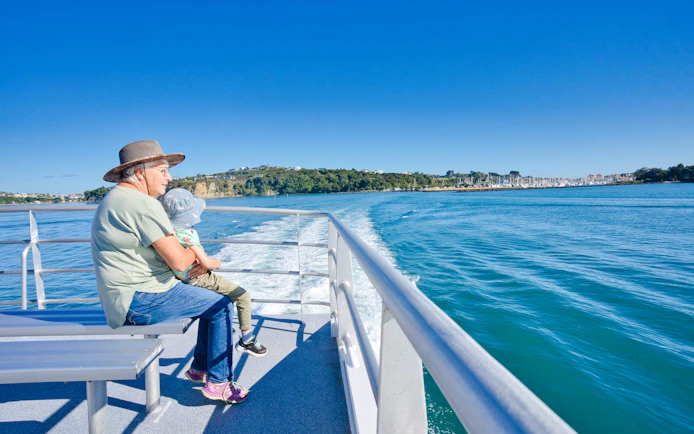 Elderly person and child on ferry to Tiritiri Matangi Island from Auckland.