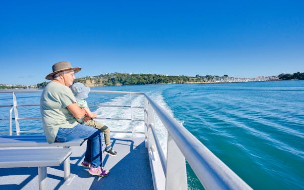 Elderly person and child on ferry to Tiritiri Matangi Island from Auckland.