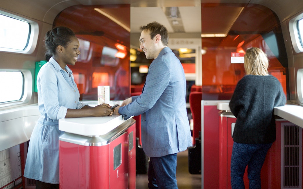 Euro Rail passengers at onboard cafe counter.