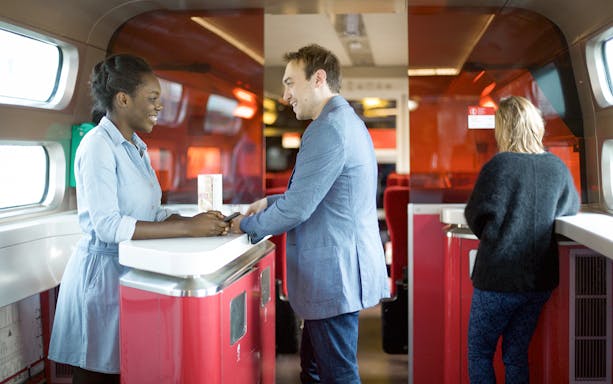 Euro Rail passengers at onboard cafe counter.