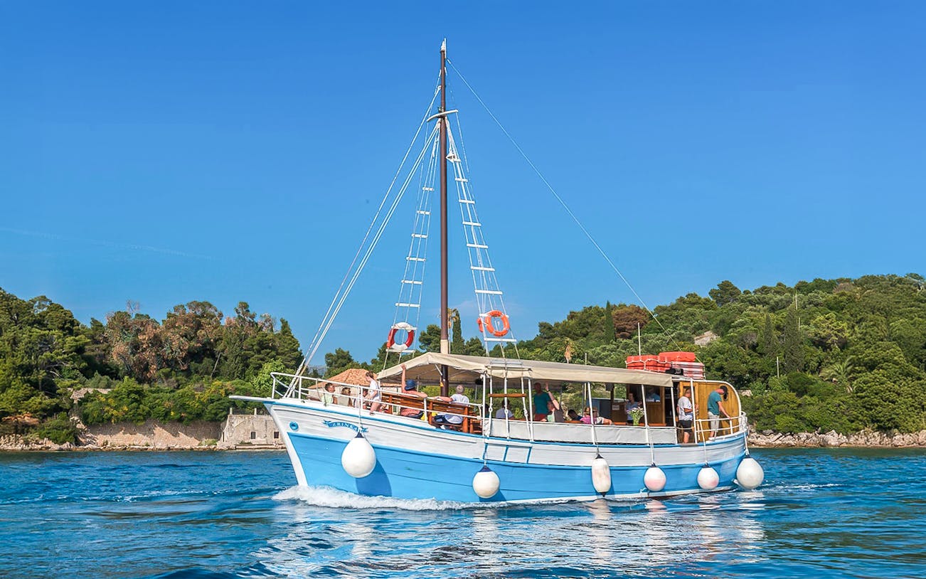 Boat cruising near Elaphiti Islands, Croatia, showcasing scenic coastal views.