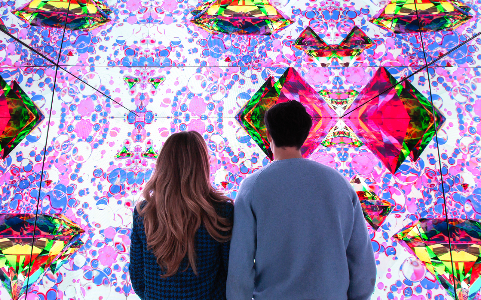 Visitors viewing digital art installation at Moco Museum.