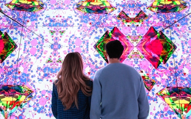 Visitors viewing digital art installation at Moco Museum.