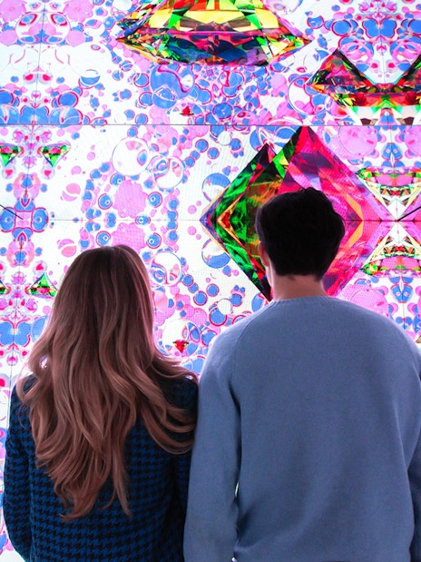 Visitors viewing digital art installation at Moco Museum.