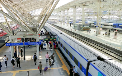 Passengers boarding a train at a busy station in South Korea, KORAIL Pass.