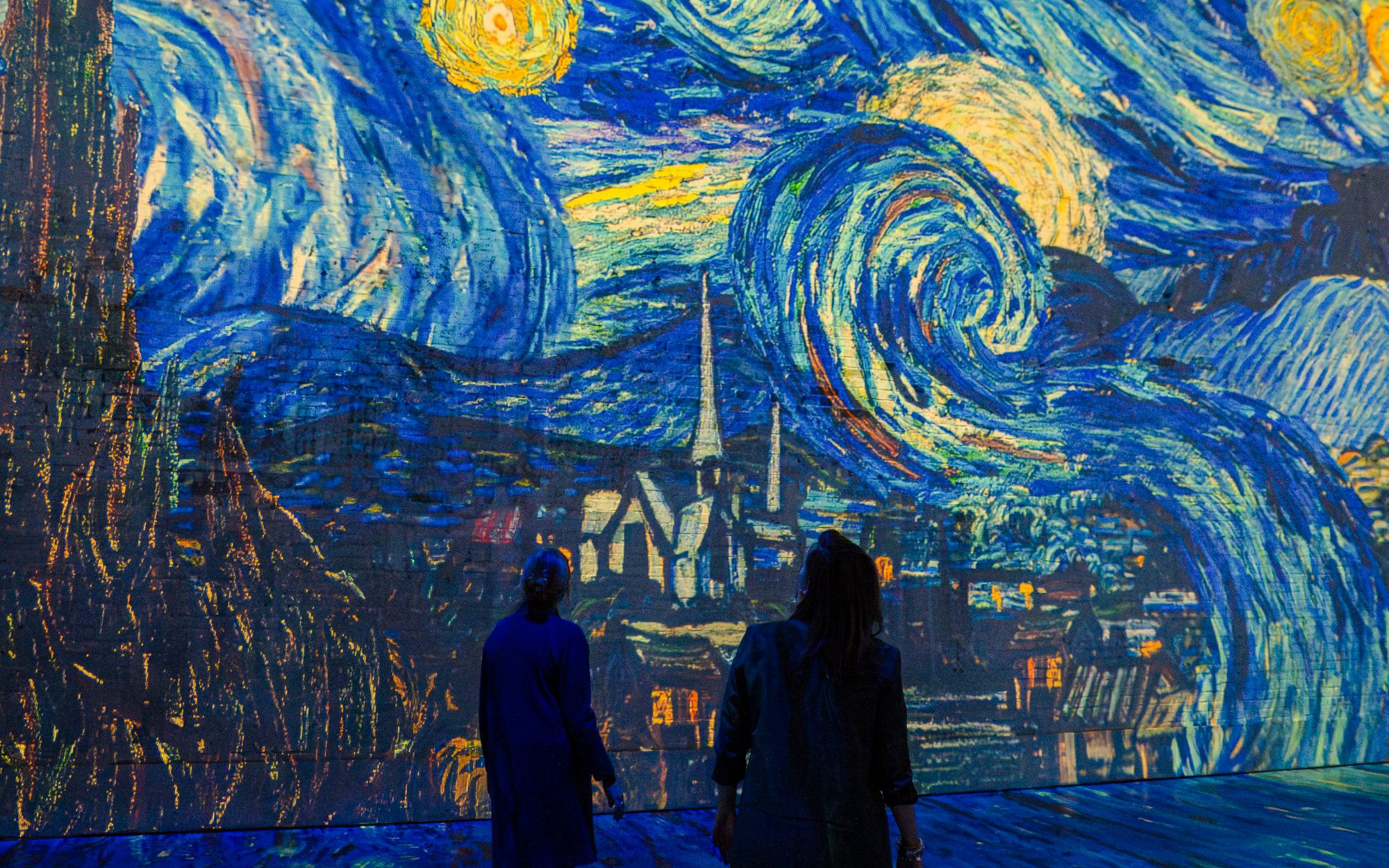 Visitors viewing Van Gogh's Starry Night at Dutch Masters Exhibition, Fabrique des Lumières.