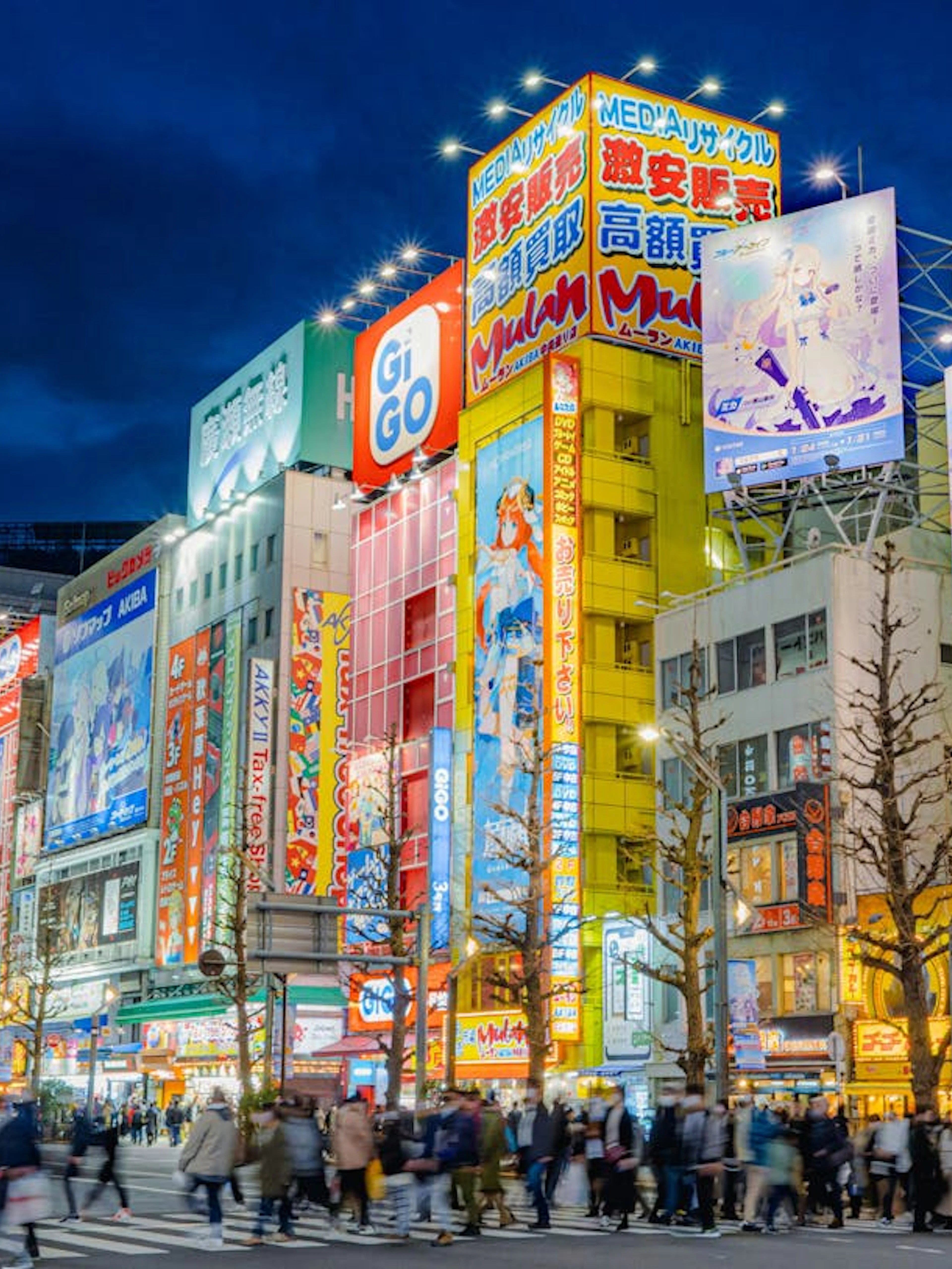 Akihabara street scene with anime billboards and crowds, Tokyo, Japan.