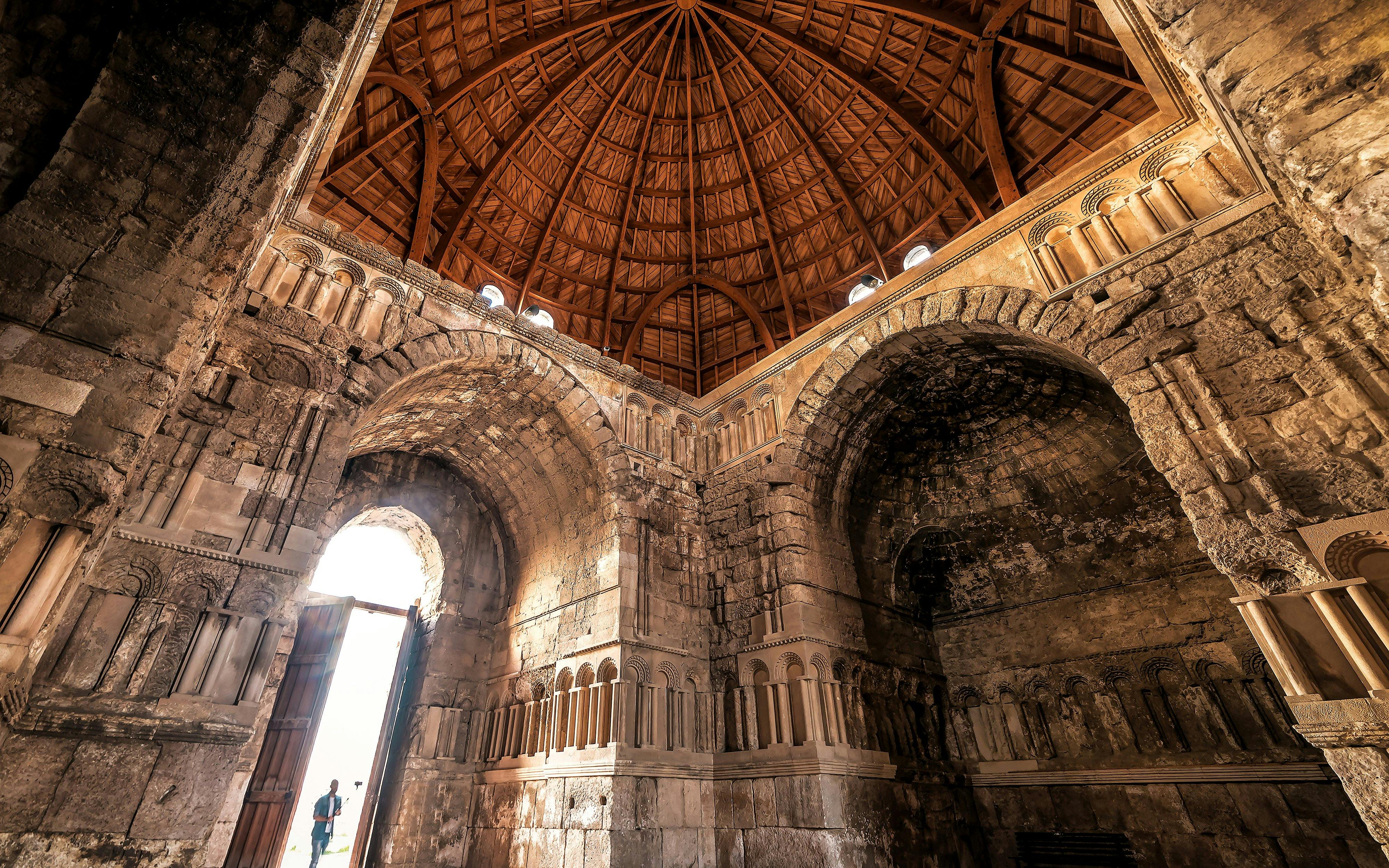 Interior of Umayyad Palace with stone arches and wooden dome, Amman Citadel.