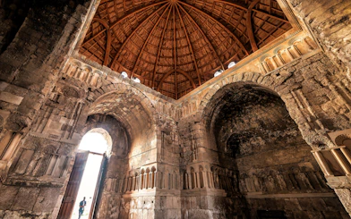 Interior of Umayyad Palace with stone arches and wooden dome, Amman Citadel.