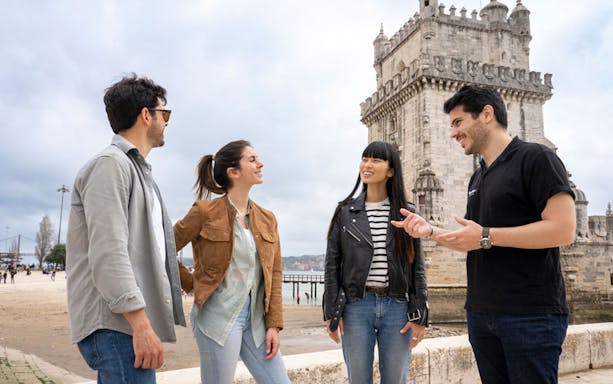 Tour group at Belém Tower, Lisbon, during a wine tour with 4WD vineyard experience.