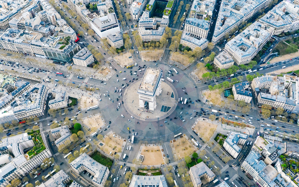 Aerial view of Arc de Triomphe and surrounding streets in Paris, France.