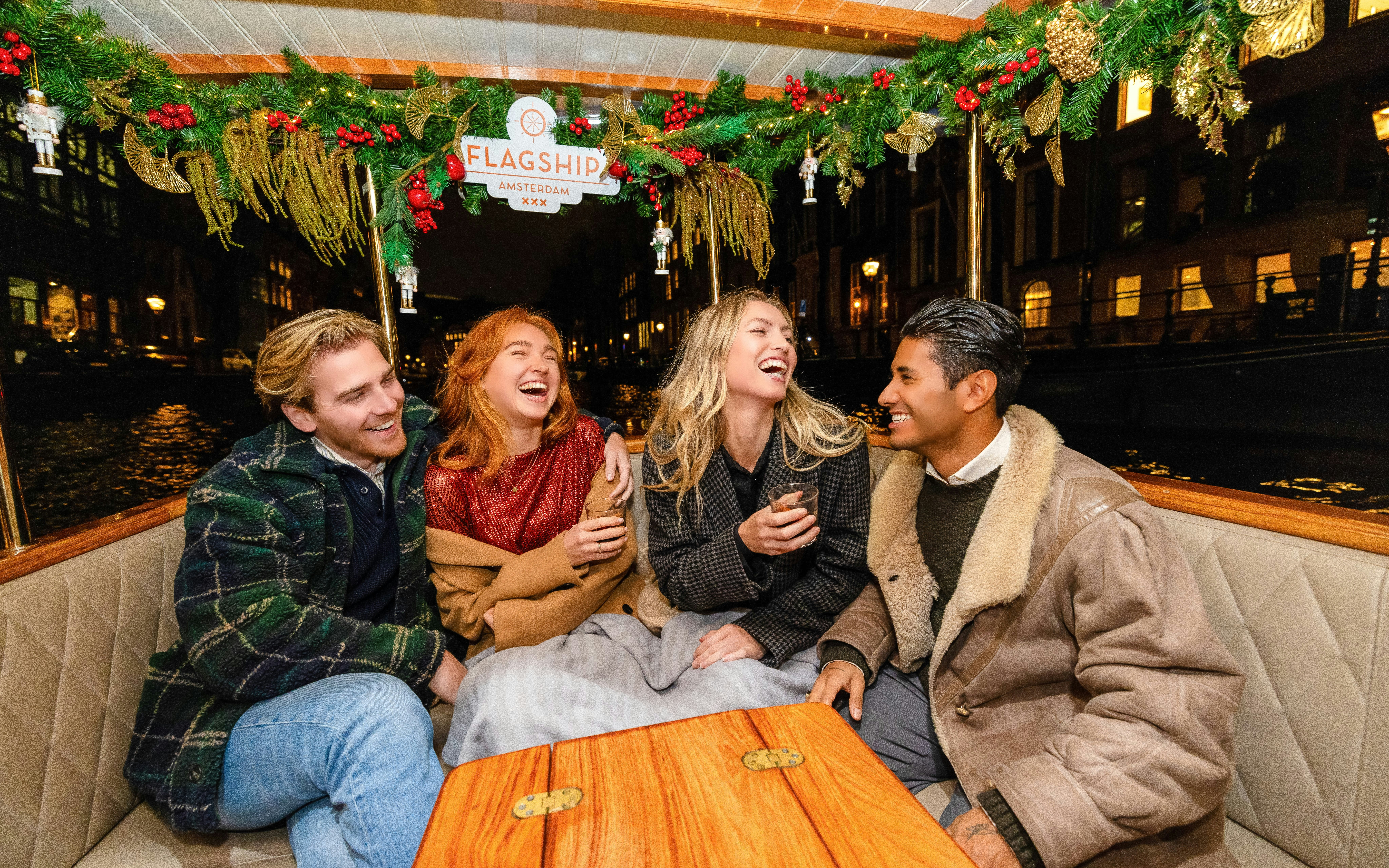 Guests enjoying the Luxury Heated Saloon Boat Evening Cruise in Amsterdam.