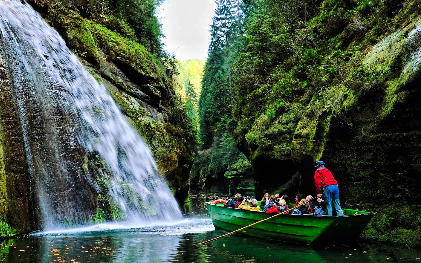 Boat ride through Edmund's Gorge with waterfall, Bohemian Switzerland National Park, Czech Republic.