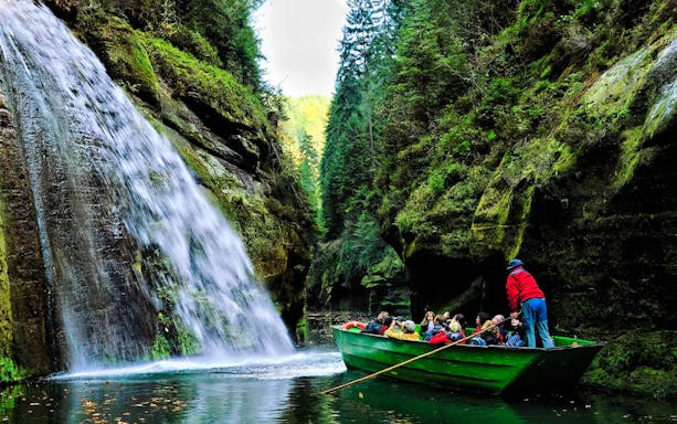 Boat ride through Edmund's Gorge with waterfall, Bohemian Switzerland National Park, Czech Republic.