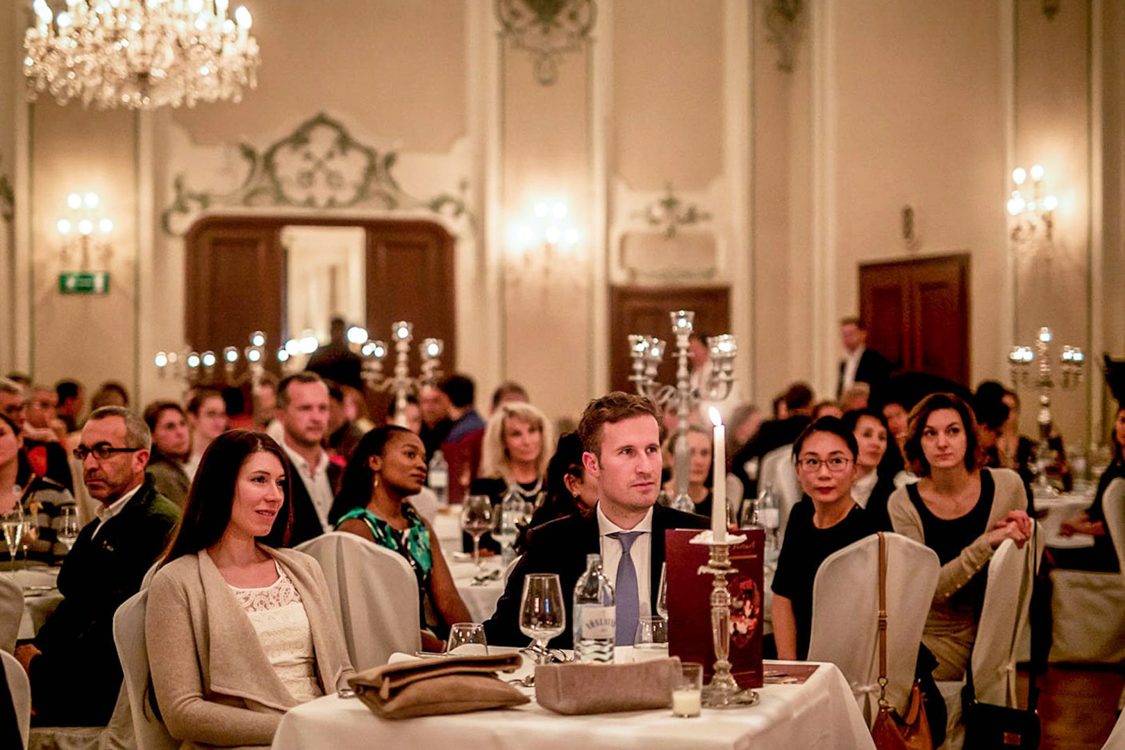 Audience enjoying a Mozart concert in Salzburg with musicians in period costumes in a historic venue.