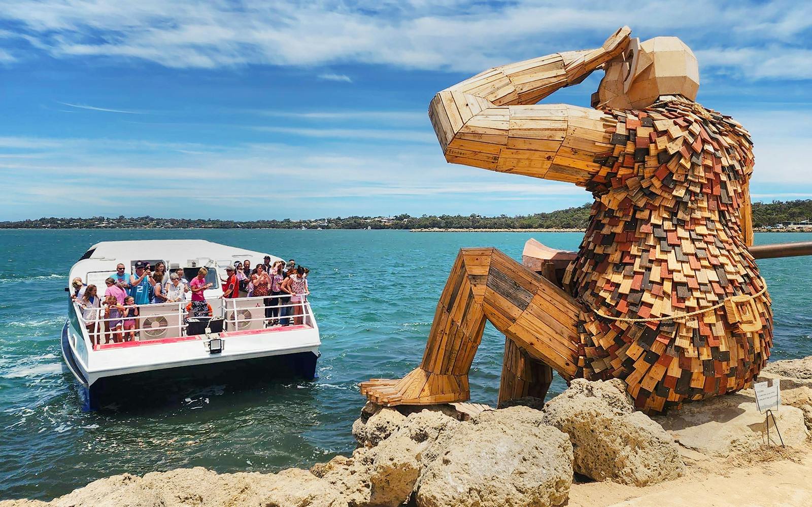 Boat tour near the Giants of Mandurah sculpture in Australia.