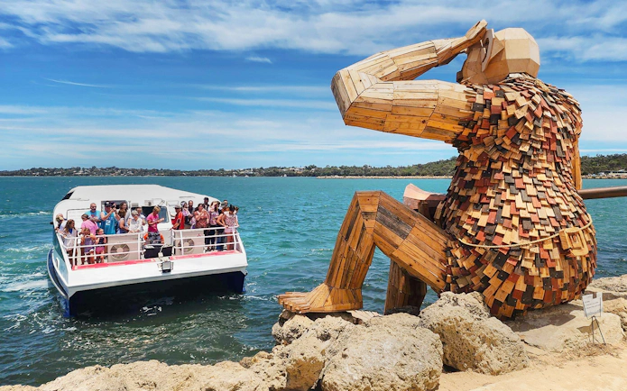 Boat tour near the Giants of Mandurah sculpture in Australia.