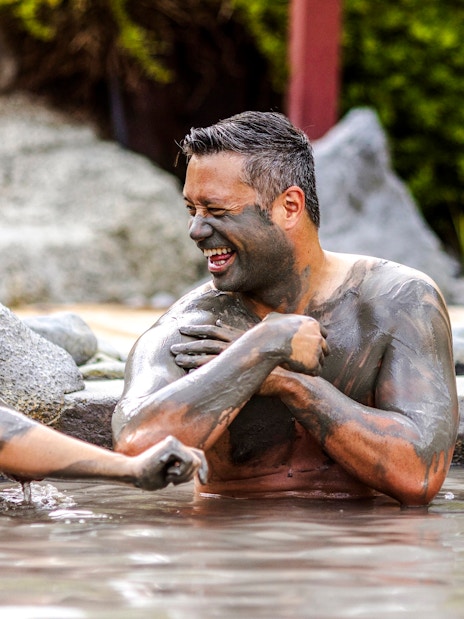 People enjoying a mud bath at Hell's Gate geothermal park.