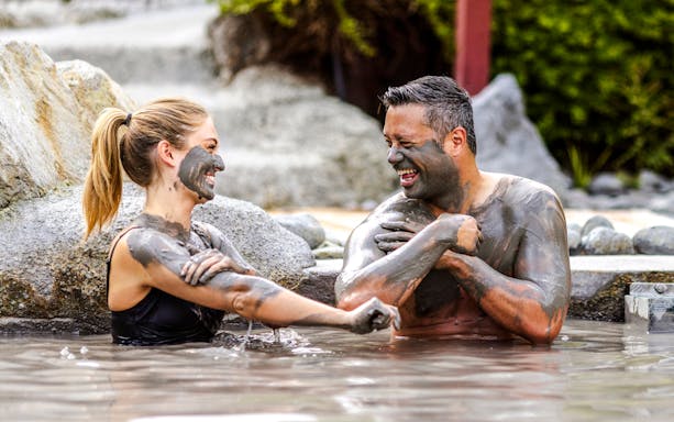 People enjoying a mud bath at Hell's Gate geothermal park.