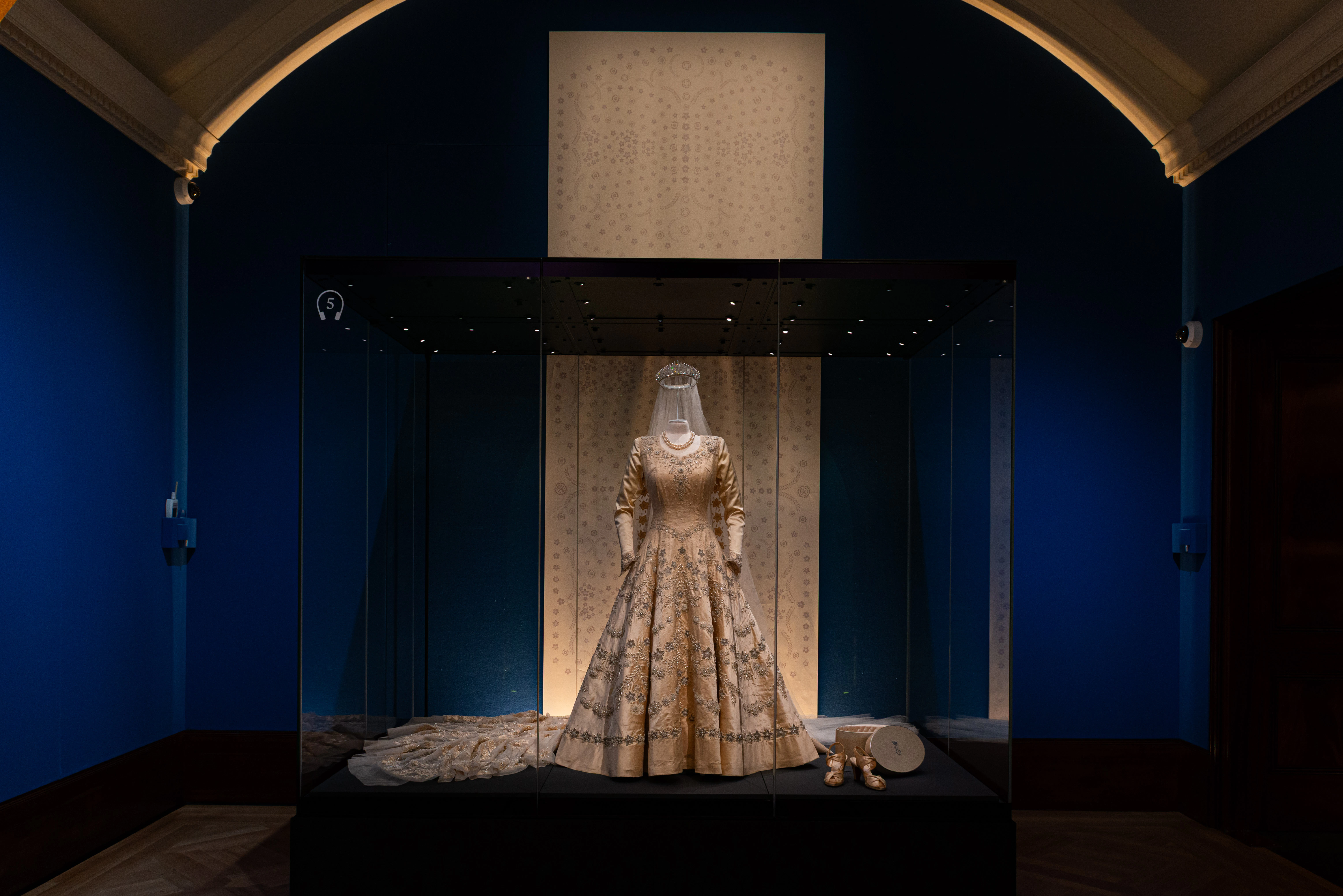 Exhibit of an ornate gown and accessories at The King's Gallery, Buckingham Palace.