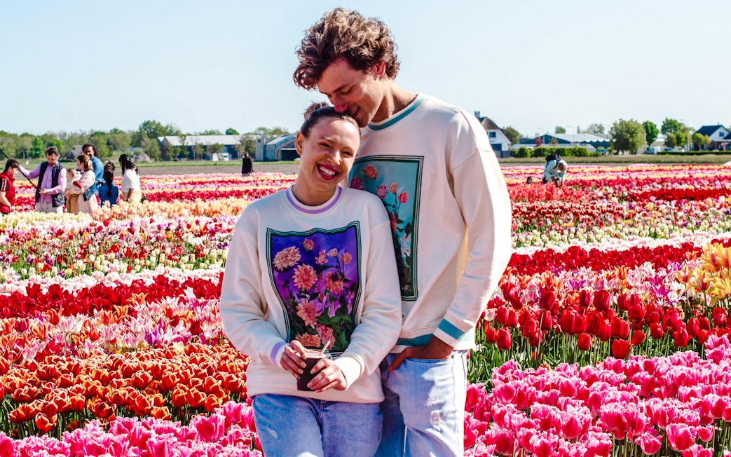 Couple enjoying tulip fields at sunset, Tulip Experience Amsterdam.