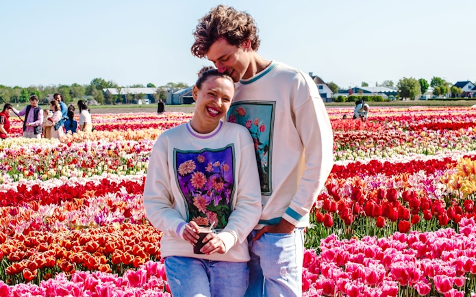 Couple enjoying tulip fields at sunset, Tulip Experience Amsterdam.