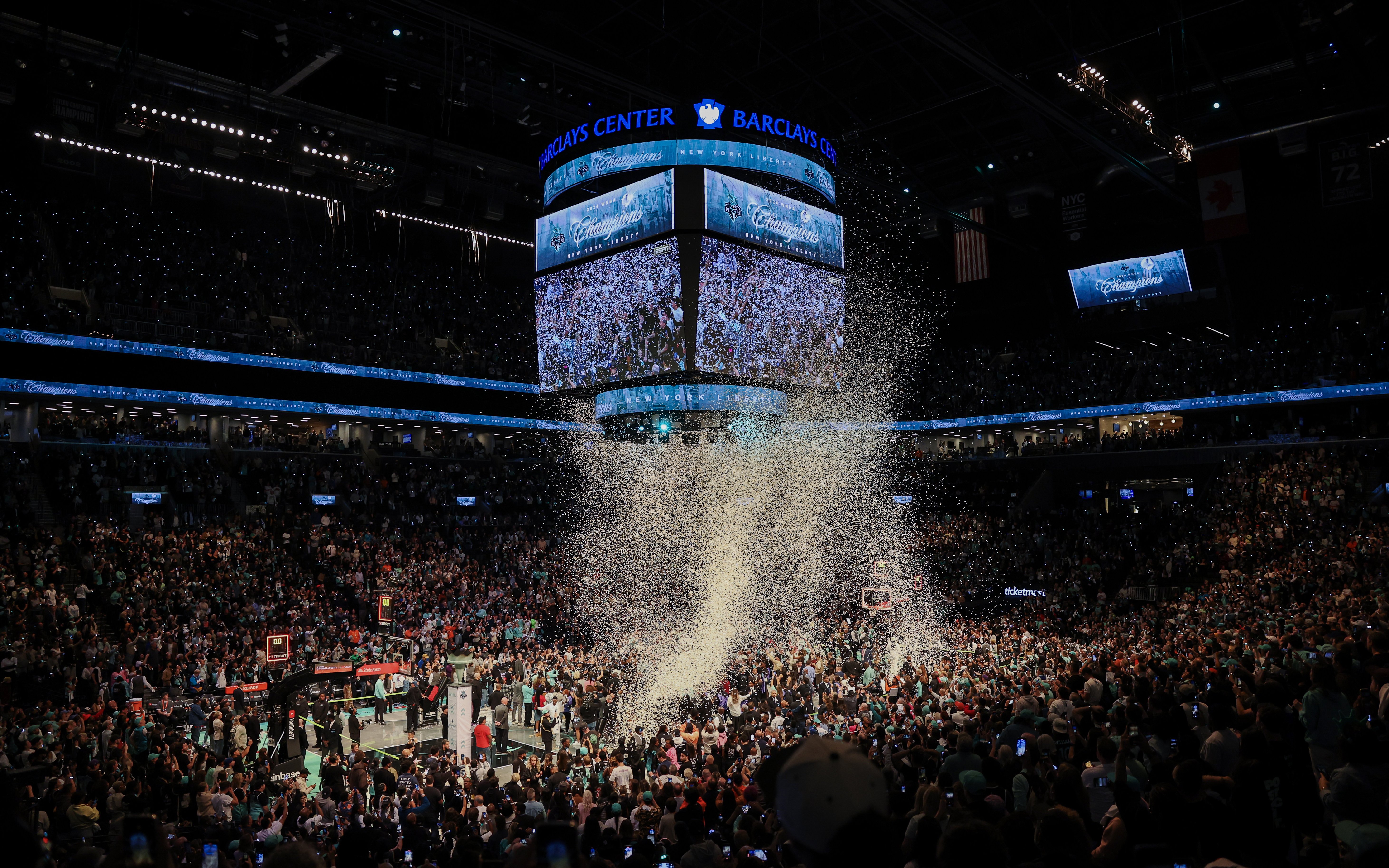 Fans celebrating at Barclays Center during New York Liberty basketball game.