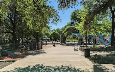 San Antonio park with playground and walking paths, part of the Crash the Wedding Save Lily game.