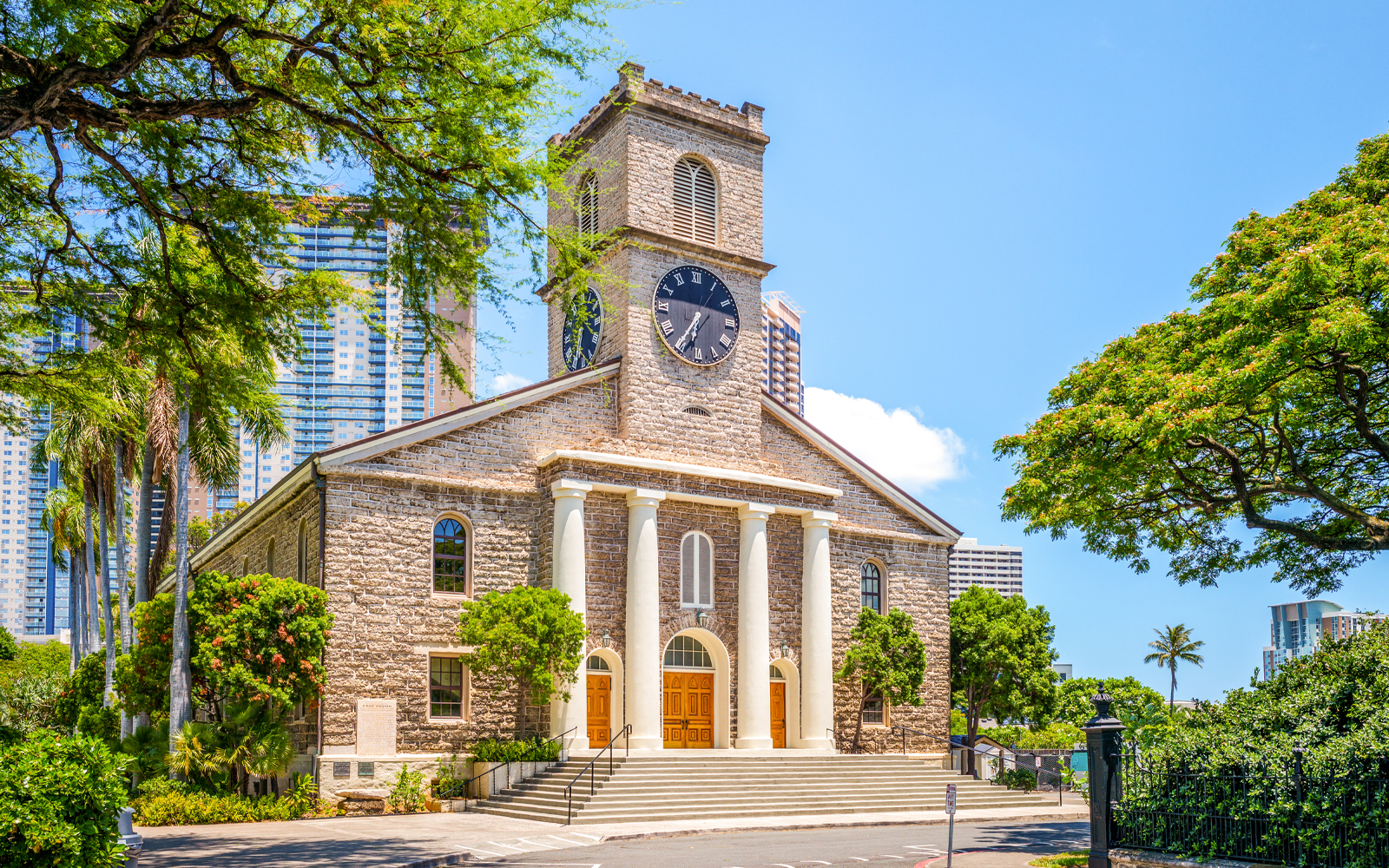 Kawaiahao Church with clock tower and palm trees in Honolulu, Oahu, Hawaii.