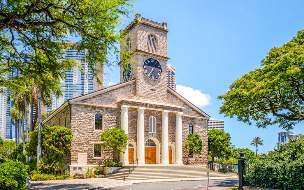 Kawaiahao Church with clock tower and palm trees in Honolulu, Oahu, Hawaii.