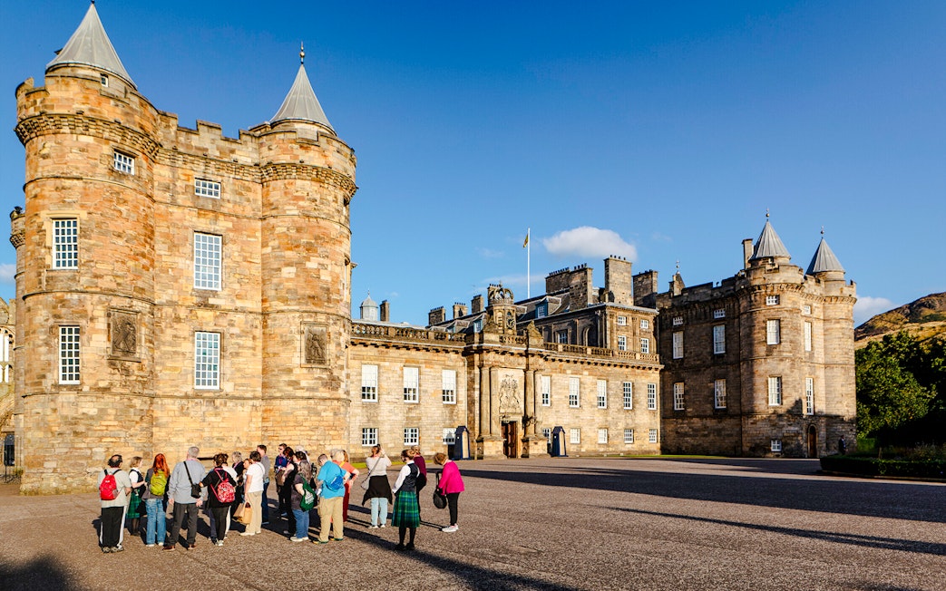 Tour group gathered outside the Palace of Holyroodhouse, Edinburgh.