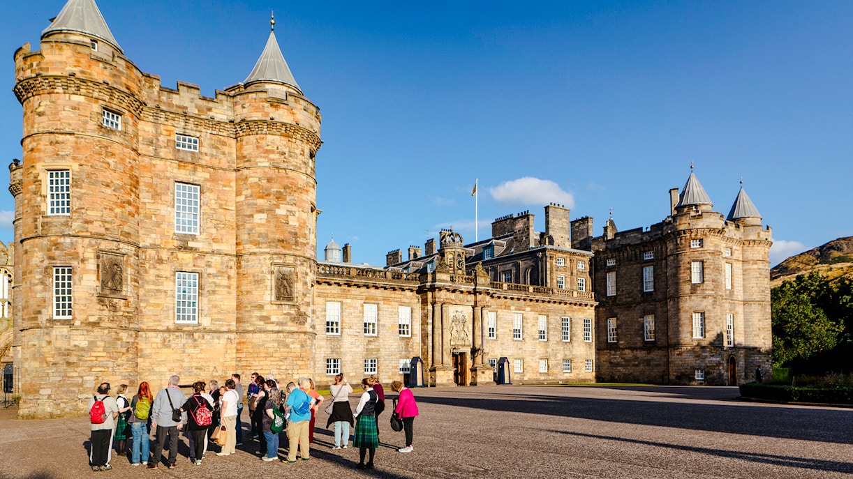 Tour group gathered outside the Palace of Holyroodhouse, Edinburgh.