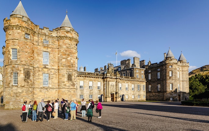 Tour group gathered outside the Palace of Holyroodhouse, Edinburgh.