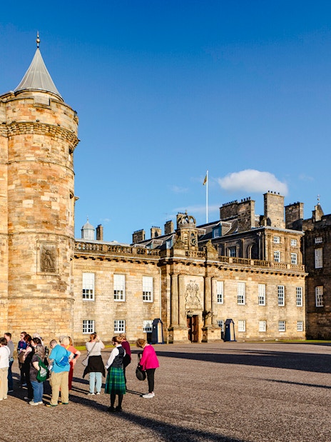 Tour group gathered outside the Palace of Holyroodhouse, Edinburgh.