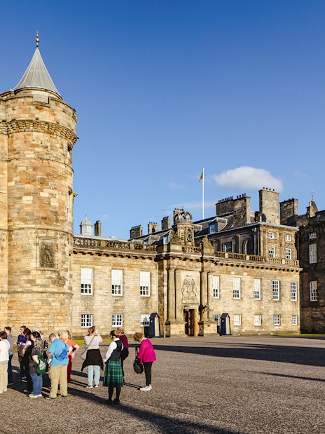Tour group gathered outside the Palace of Holyroodhouse, Edinburgh.