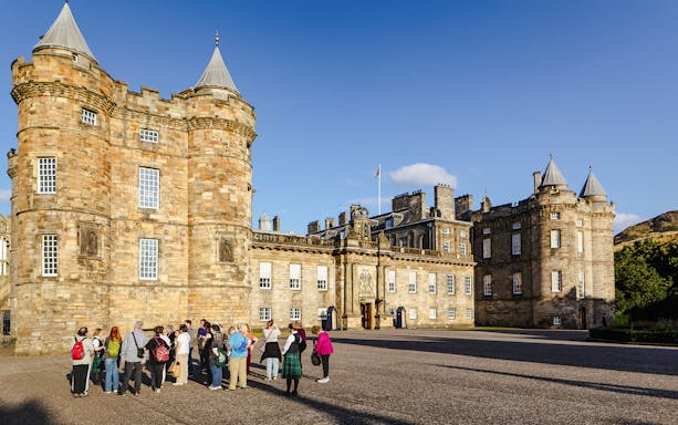 Tour group gathered outside the Palace of Holyroodhouse, Edinburgh.