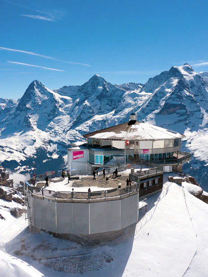 Schilthorn observation deck with panoramic views of snow-covered Alps in Interlaken, Switzerland.