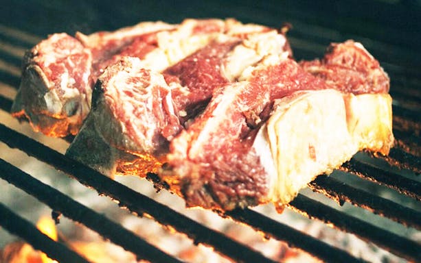 Grilled steak on open flame during Guided Cider House Experience from San Sebastian.