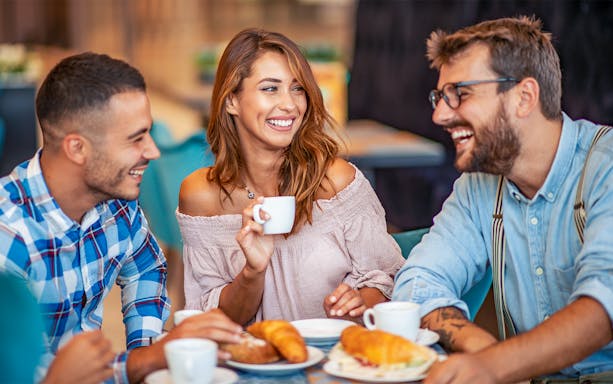 Friends enjoying breakfast at Opéra-Grand Café Capucines in Paris.