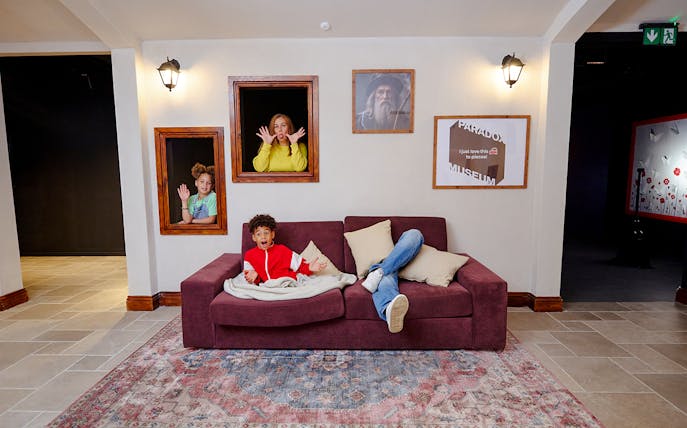 Guests interacting with optical illusions at Paradox Museum London.