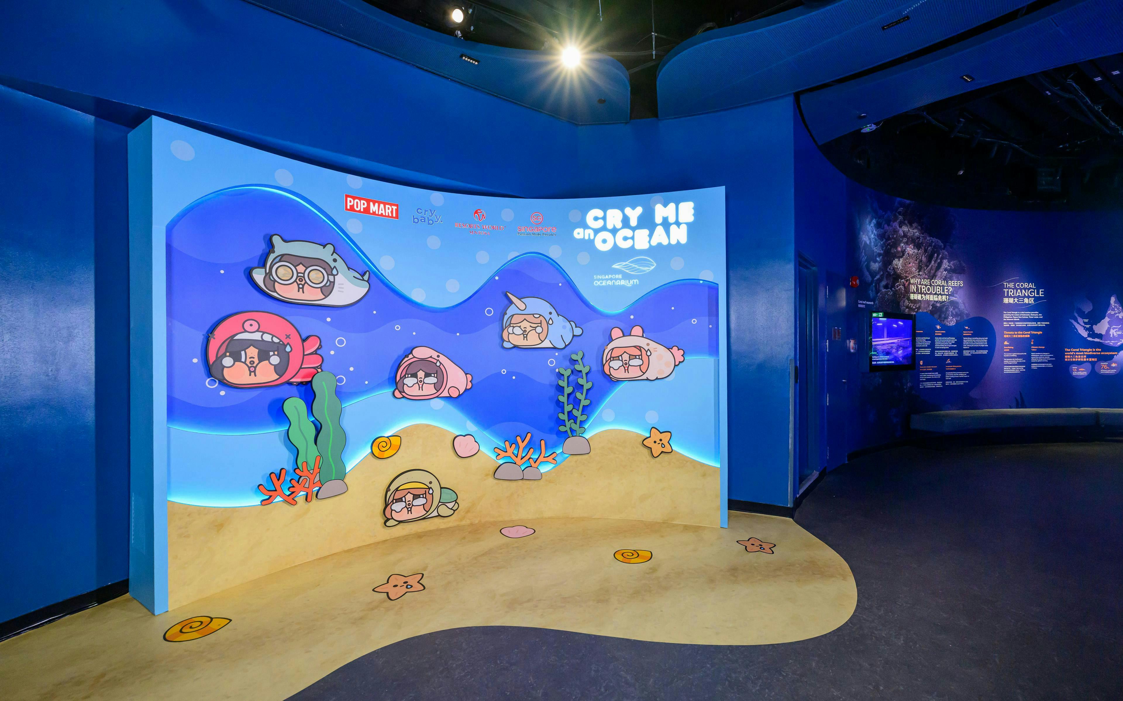 Interactive display at Singapore Oceanarium featuring cartoon sea creatures and educational panels.