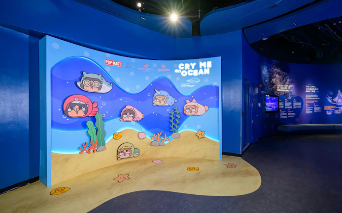 Interactive display at Singapore Oceanarium featuring cartoon sea creatures and educational panels.
