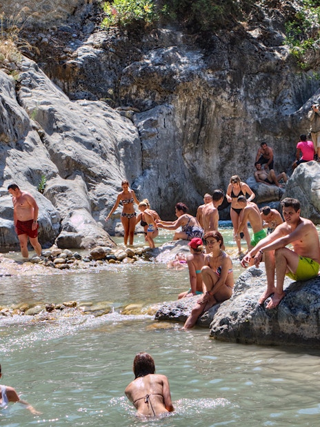 People enjoying a natural pool during the Antalya Jeep Safari tour.